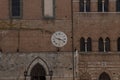 The Vintage Clock Hanging on an old brick wall Siena Tuscany Royalty Free Stock Photo