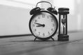 Vintage clock and hourglass or sand-glass for time management