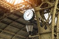Vintage clock and lantern on train station with building roof
