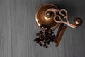 Vintage coffee grinder with coffee beans and cinnamon sticks on wooden surface Royalty Free Stock Photo