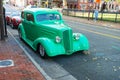 Vintage collectible BMW 327 is parked outside a cafe in an old town in Virginia