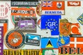 A vintage collection of travel stickers collected from various parts of the world