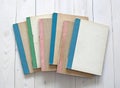 Vintage color notebooks on white wooden background