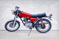 Vintage color style of old classic motorcycle standing against w Royalty Free Stock Photo