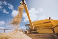 Vintage combine harvester unloading wheat grains into trailer Royalty Free Stock Photo