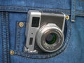 Vintage compact photo camera in jeans pocket. Blogging, travel and tourism concept Royalty Free Stock Photo