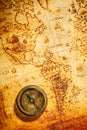 Vintage Compass Lies On An Ancient World Map.