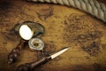 Vintage Compass and magnifying glass lies on an ancient world map - adventure stories background Royalty Free Stock Photo