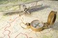 A vintage compass on the map and an airplane Royalty Free Stock Photo