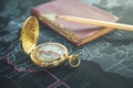 Vintage compass , old notebook, pencil on modern world map Royalty Free Stock Photo