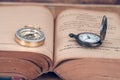 Vintage Compass and pocket watch on books. Royalty Free Stock Photo