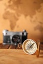 Vintage compass with sheet of paper on table against blurred background Royalty Free Stock Photo