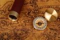 Vintage compass with spyglass telescope and cinnamon spices on an old world map - trade and explorer concept Royalty Free Stock Photo