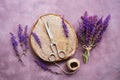 Vintage composition, bouquet of wild flowers of sage, plank stump, old scissors and a ball of thread on a purple rustic background