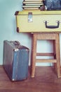 Vintage Composition with old books, suitcases and stool. Royalty Free Stock Photo