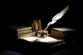 Vintage concept. Old fountain pen, books and inkwell on a black background Royalty Free Stock Photo