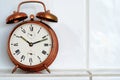 Vintage copper alarm clock on the mantelshelf Royalty Free Stock Photo