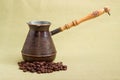 Vintage copper coffee pot and coffee beans on textile surface Royalty Free Stock Photo