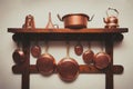 Vintage copper cookware collection on wooden shelf Royalty Free Stock Photo