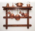 Vintage copper cookware hung on wooden shelf Royalty Free Stock Photo