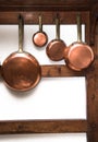 Vintage copper pans hung on wooden shelf Royalty Free Stock Photo