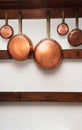 Vintage copper pans hung on wooden shelf Royalty Free Stock Photo