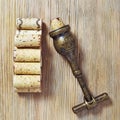 Vintage corkscrew and heap used wine corks on wooden background. Spin and stopper corks from red wine Royalty Free Stock Photo