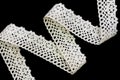 Vintage cotton lace braid for decoration on black background