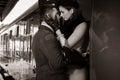 Vintage couple embracing on railway station platform as train is about to depart Royalty Free Stock Photo