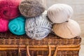 Vintage crafts wicker chest, clews, balls of multi-color wool yarn, red blue white beige grey, knitting hobby concept, header bann Royalty Free Stock Photo