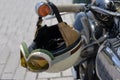 Vintage crash helmet is hanging on the handlebar of a classic oldtimer motorbike Royalty Free Stock Photo