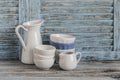 Vintage crockery on a light wooden background. Kitchen still life