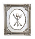 Vintage crossed spoon, fork and knife in silver openwork frame isolated on white background Royalty Free Stock Photo