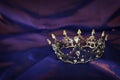 Vintage crown over dark royal purple delicate silk. fantasy medieval period