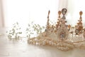 Vintage crown and pearls necklace. Wedding concept. Back light