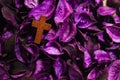 Vintage crucifix cross on dried purple flowers background Royalty Free Stock Photo