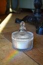 Vintage crystal sugar bowl with sugar refracts the light and lets out a rainbow Royalty Free Stock Photo