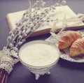 Vintage cup of cappuccino and croissants