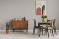 Vintage cupboard in grey elegant living room interior, copy space on empty wall