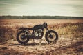 The vintage custom cafe racer in a field