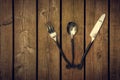 Vintage Cutlery - Fork, Spoon and Knife Fanned on Wood Background Royalty Free Stock Photo