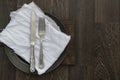 Vintage cutlery on muslin cloth on pewter plate with rustic dark Royalty Free Stock Photo