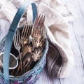 Vintage cutlery in old blue wicker basket Royalty Free Stock Photo