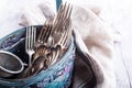 Vintage cutlery in old blue wicker basket Royalty Free Stock Photo