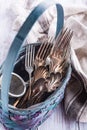Vintage cutlery in old blue wicker basket Royalty Free Stock Photo