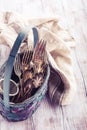 Vintage cutlery in old blue wicker basket Royalty Free Stock Photo