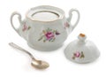 Vintage czech porcelain sugar-bowl, old style rich decorated by flower decors with teaspoon isolated on a white background