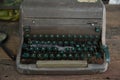 Close up of vintage damaged Typewriter on wooden table.