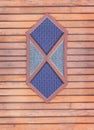 Vintage dark blue and gray stained glass window on wooden wall in horizontal background Royalty Free Stock Photo