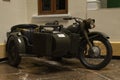 A vintage dark green seized motorcycle